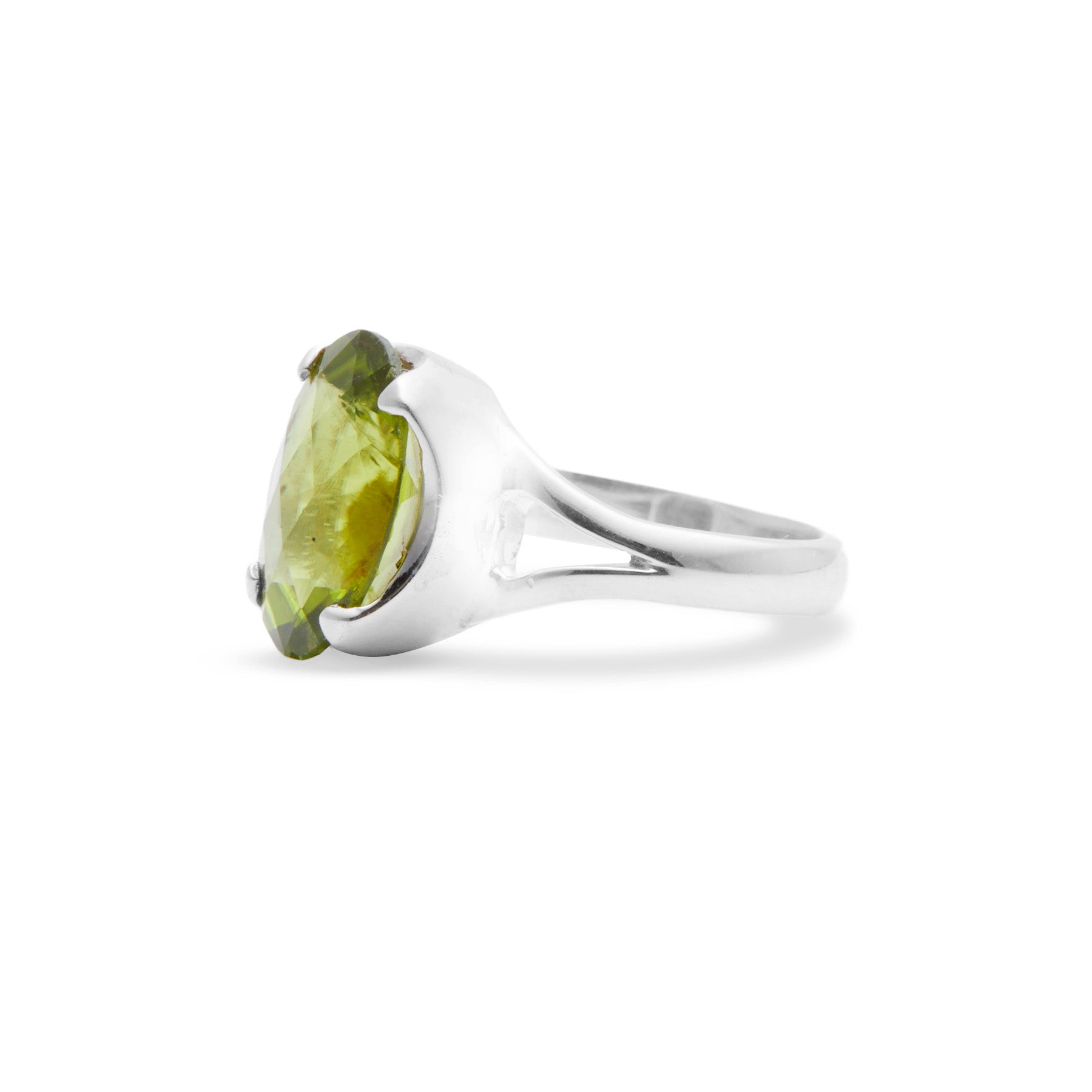 Silver ring with a green gemstone on a white background.