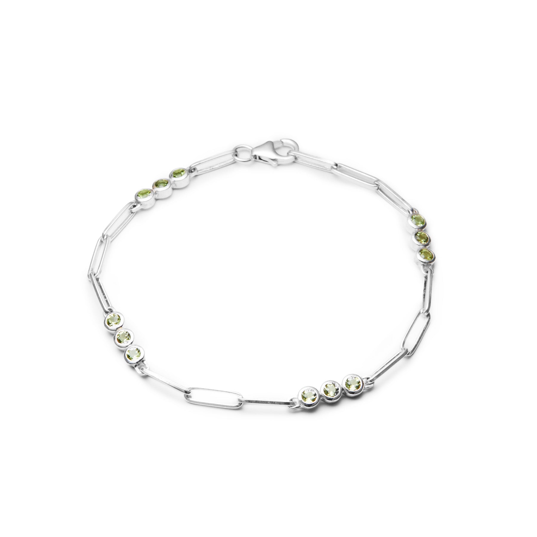 Silver bracelet with green gemstones on a white background