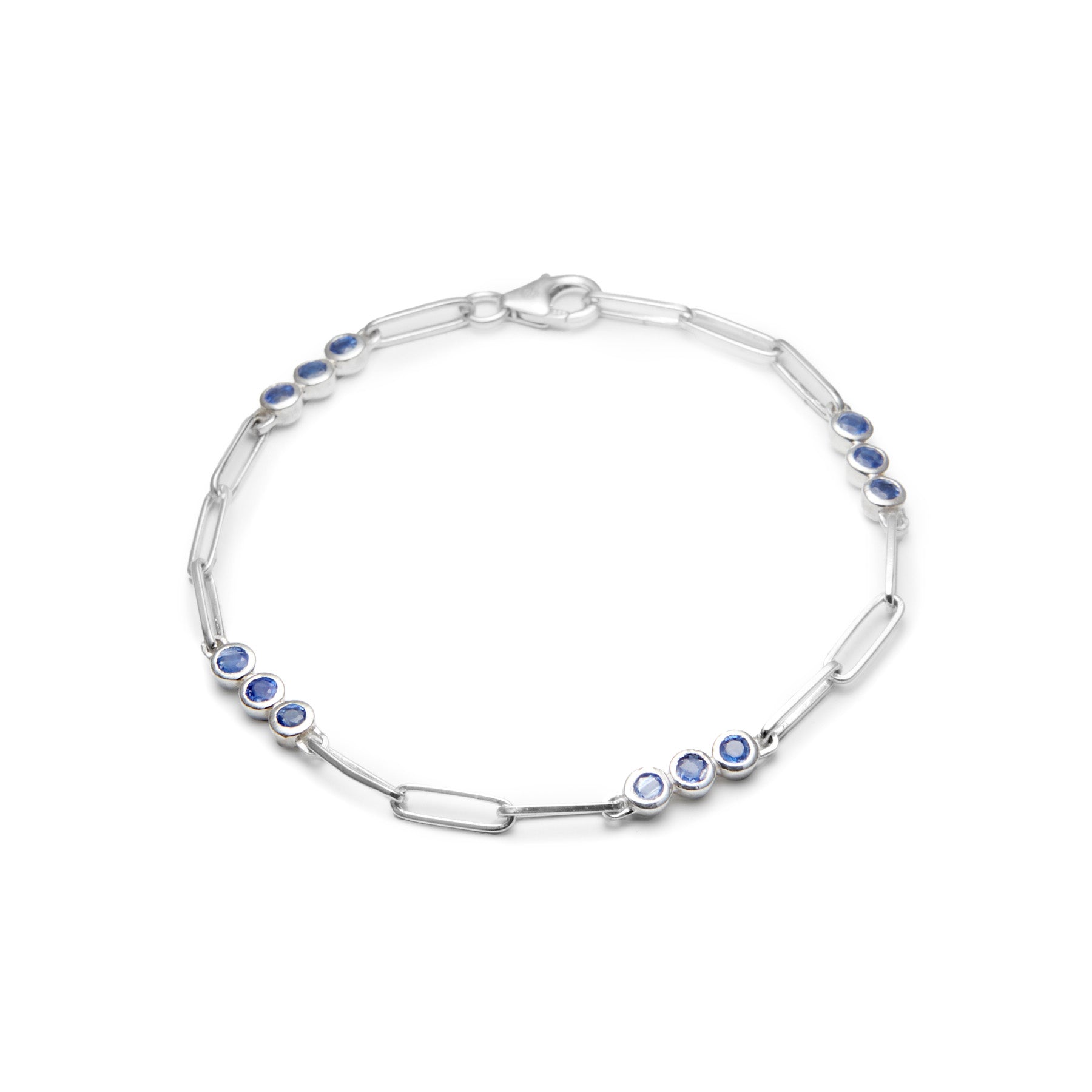Silver bracelet with blue gemstones on a white background