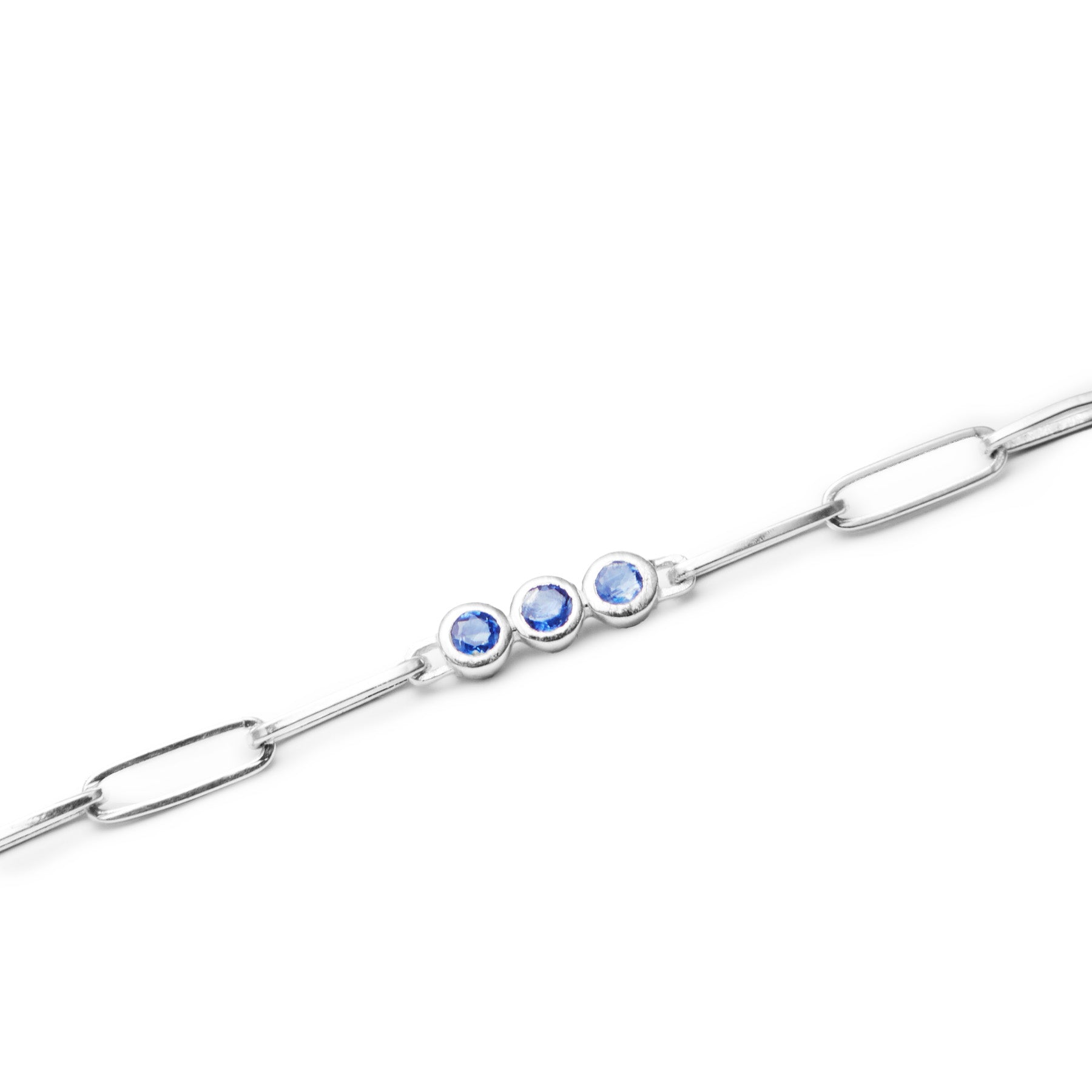 Silver bracelet with blue gemstones on a white background
