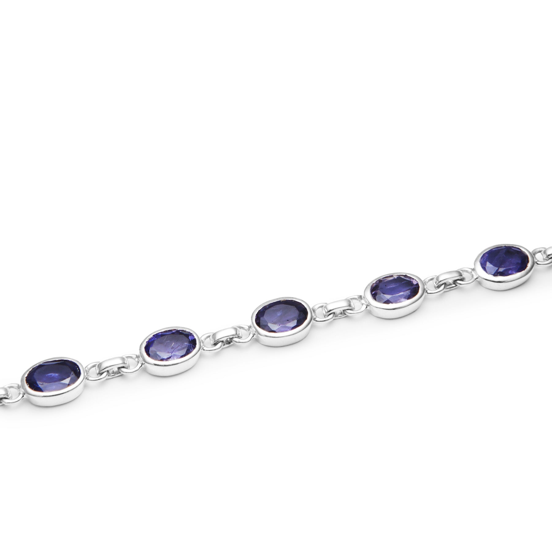 Silver bracelet with Iolite gemstones on a white background