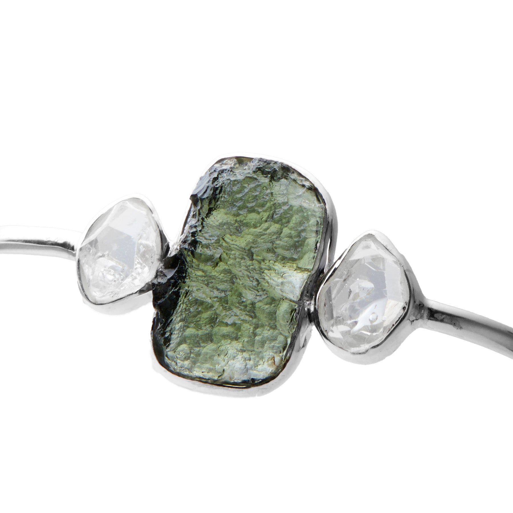 Jewelry with green and clear gemstones on a white background