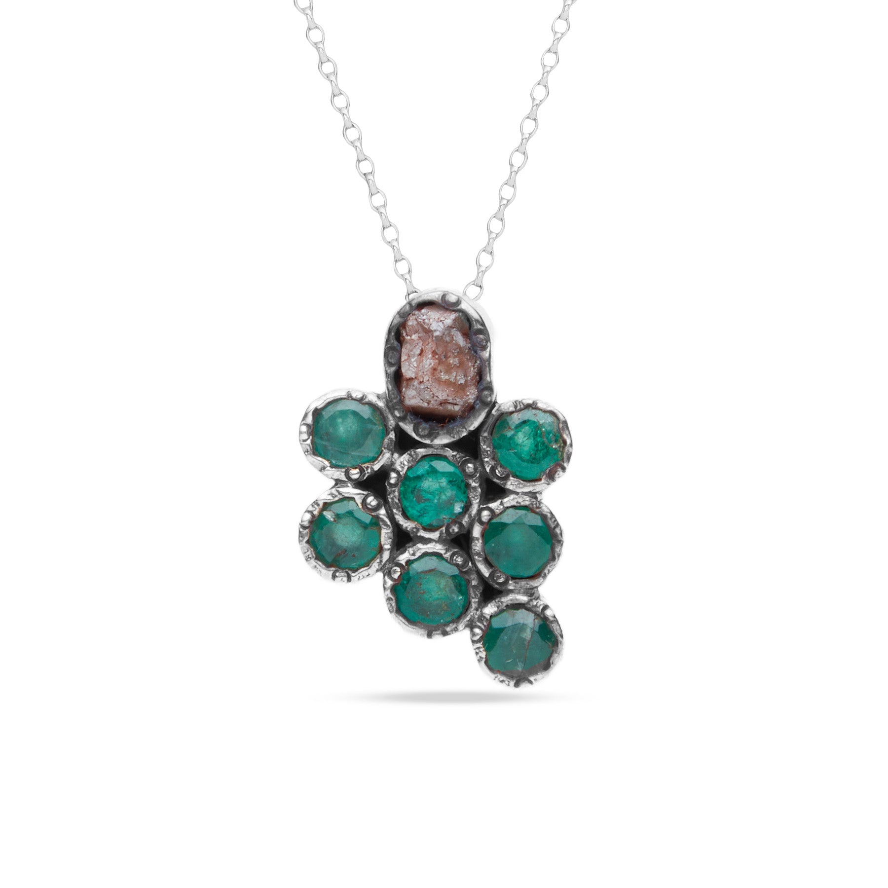 Necklace with a grape shaped pendant featuring green gemstones on a white background