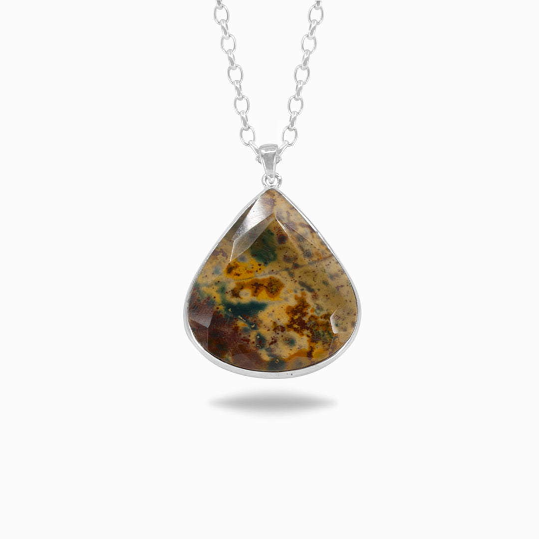 Teardrop-shaped pendant with a brown, green and yellow pattern on a white background