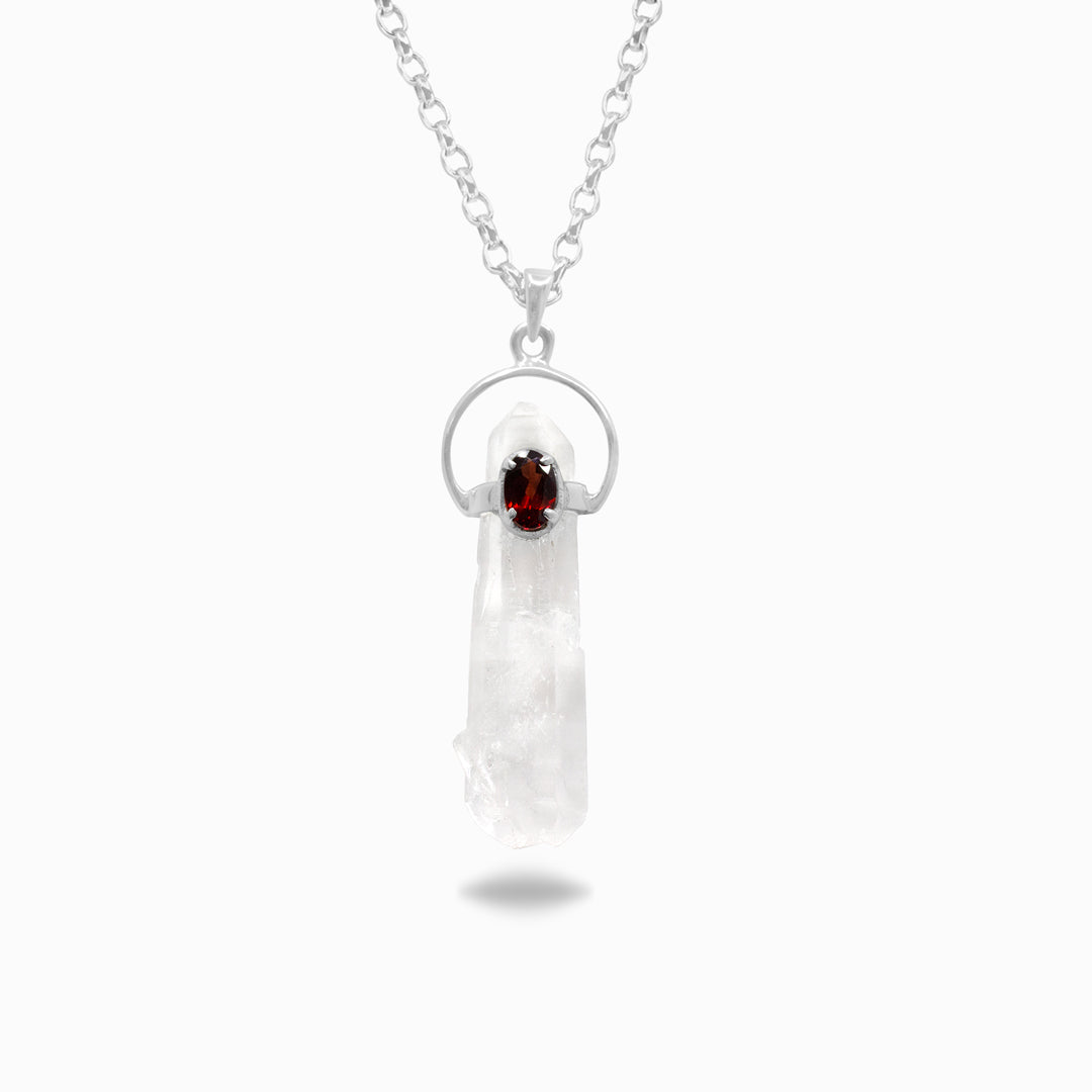 Silver necklace with a pendant featuring clear and red gemstones on a white background