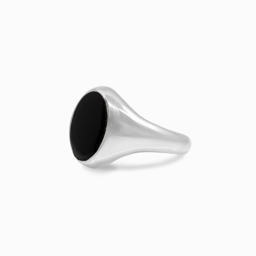 Silver ring with a black stone on a white background