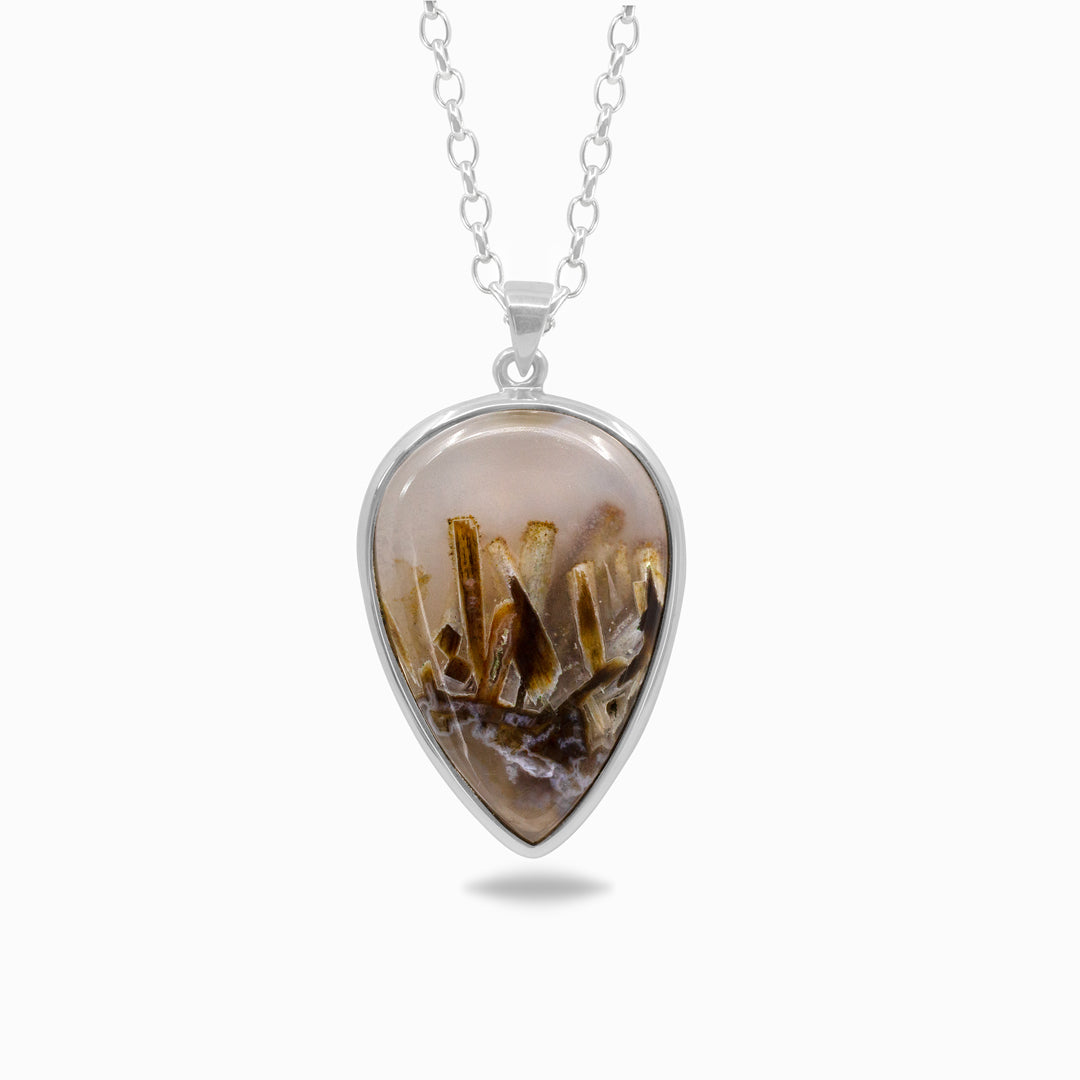 Silver necklace with a brown pendant on a white background