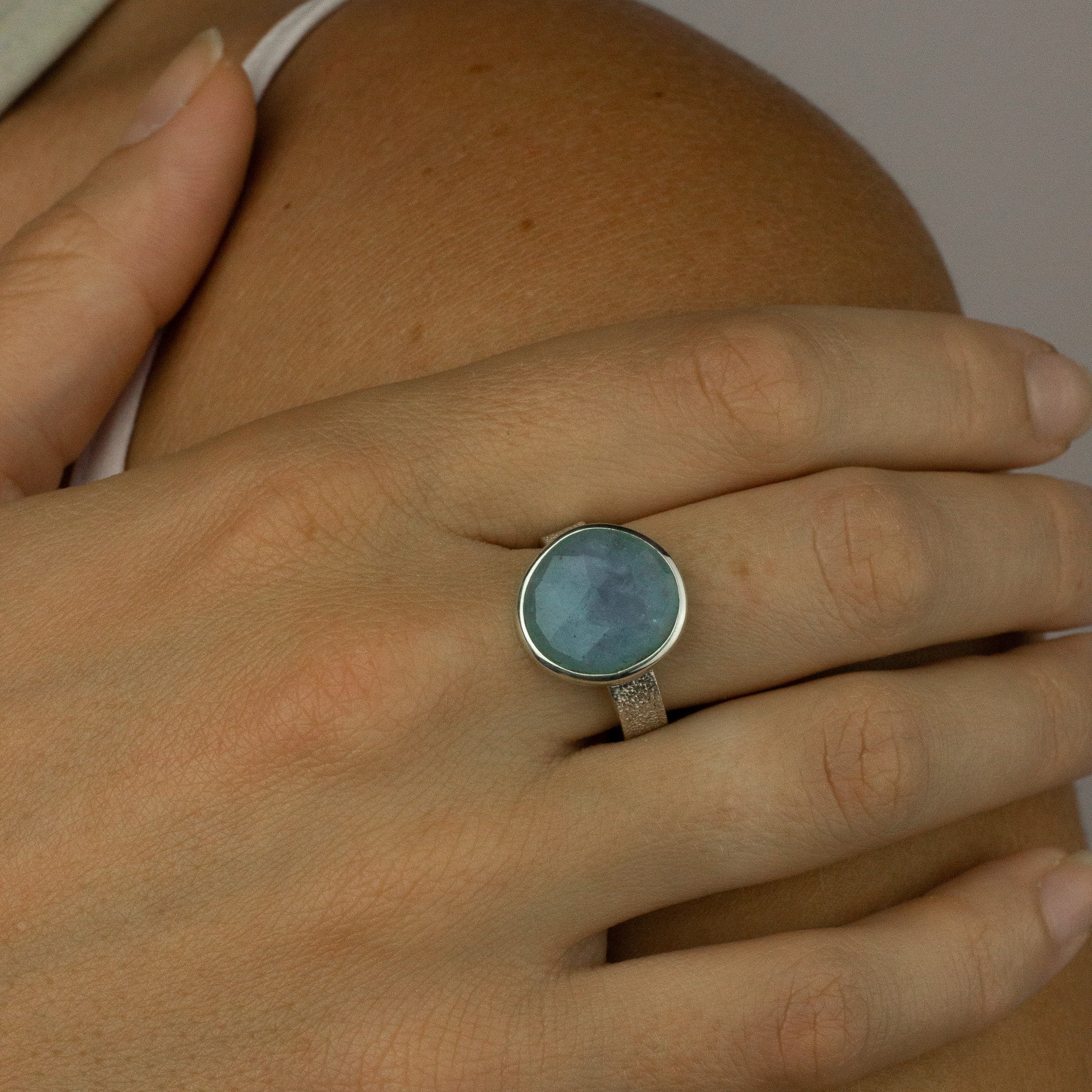 aquamarine checkerboard faceted ring with hammered hand