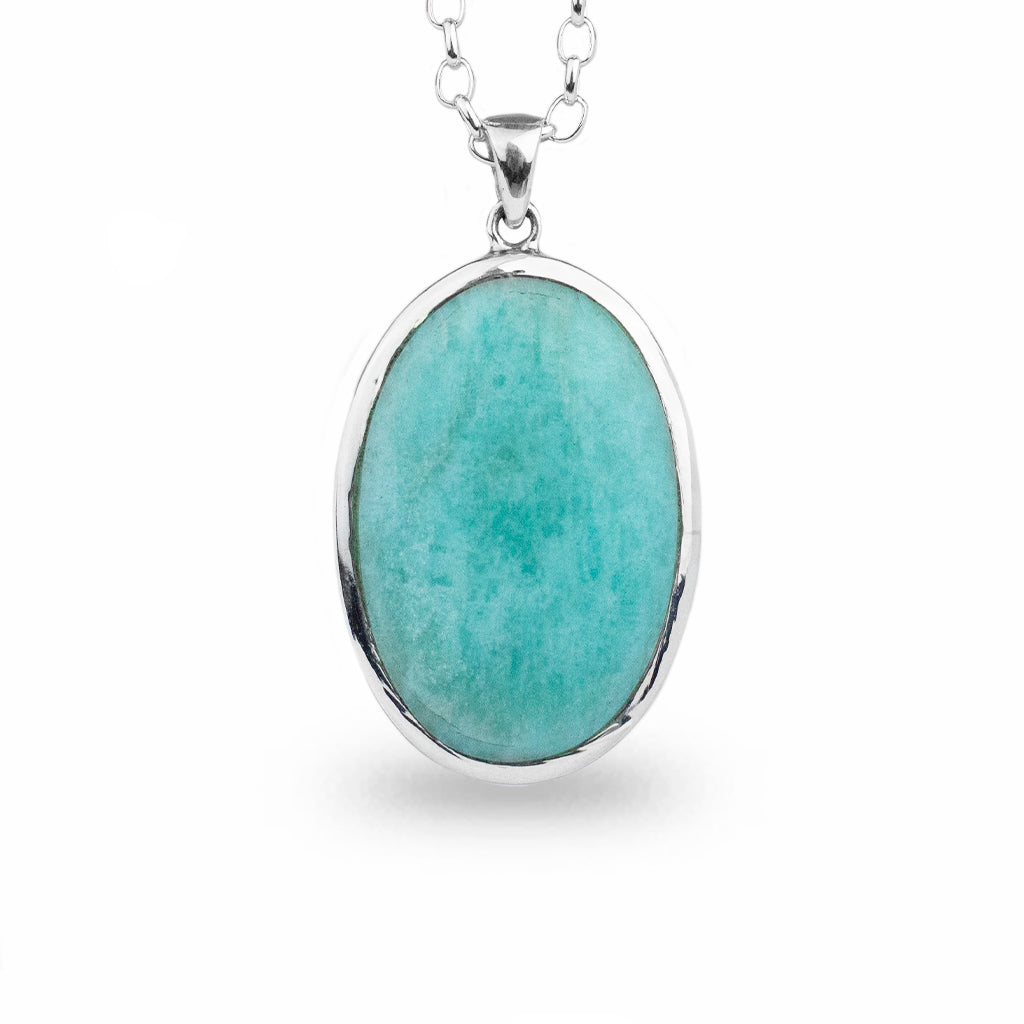 Teal blue, oval crystal. Cabochon cut set in 925 sterling silver bezel, on a 925 sterling silver chain.