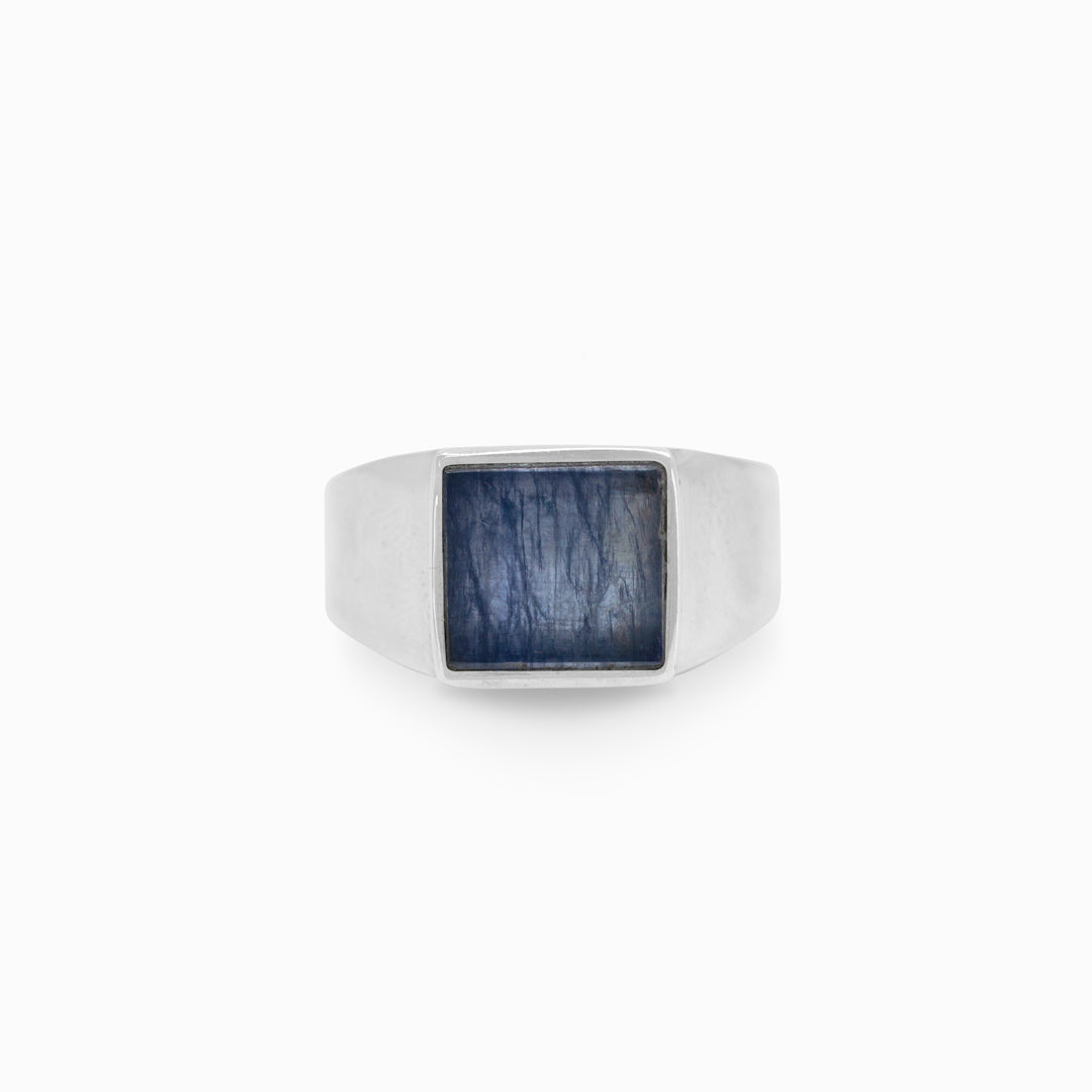 Silver ring with a blue gemstone on a white background