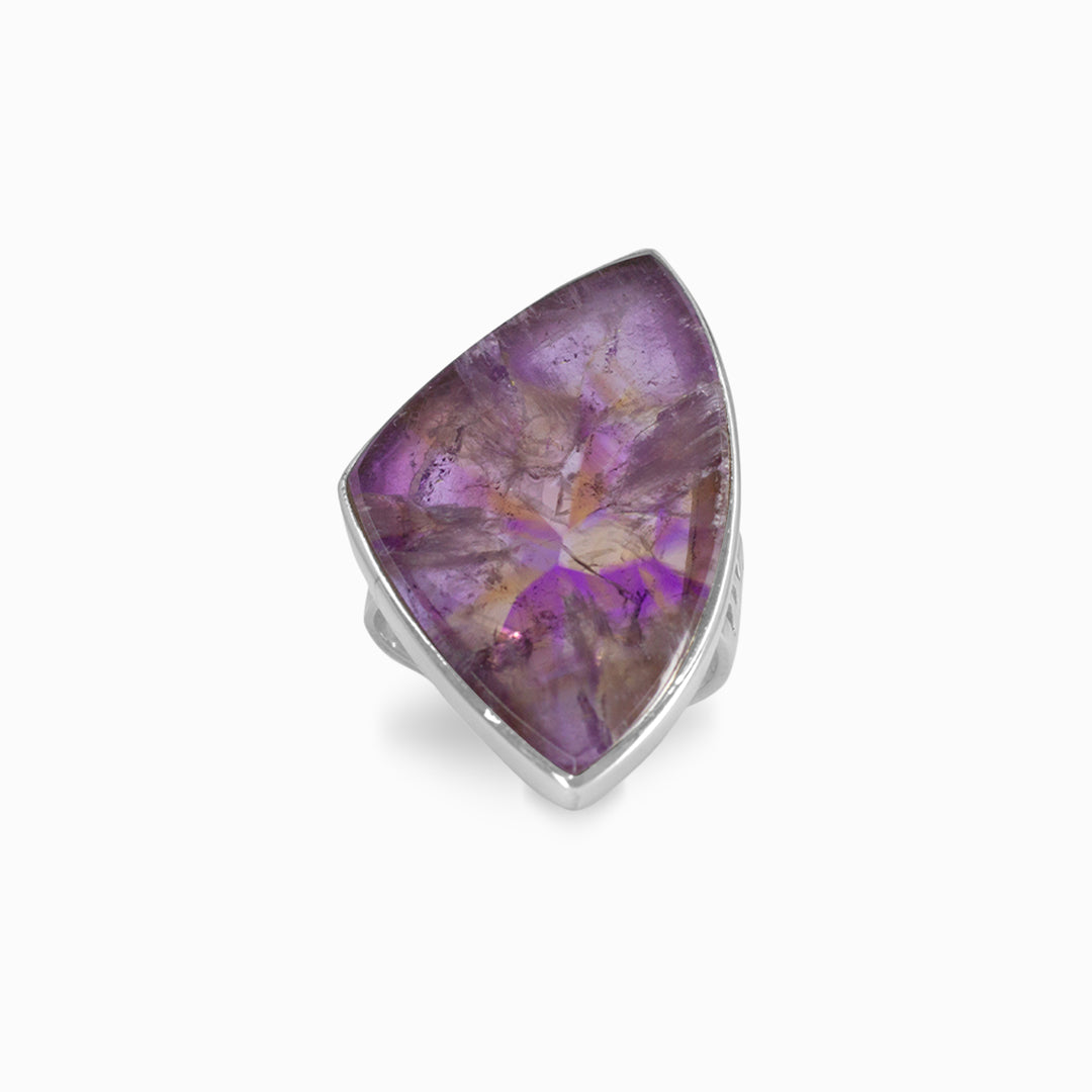 Silver ring with a purple gemstone on a white background
