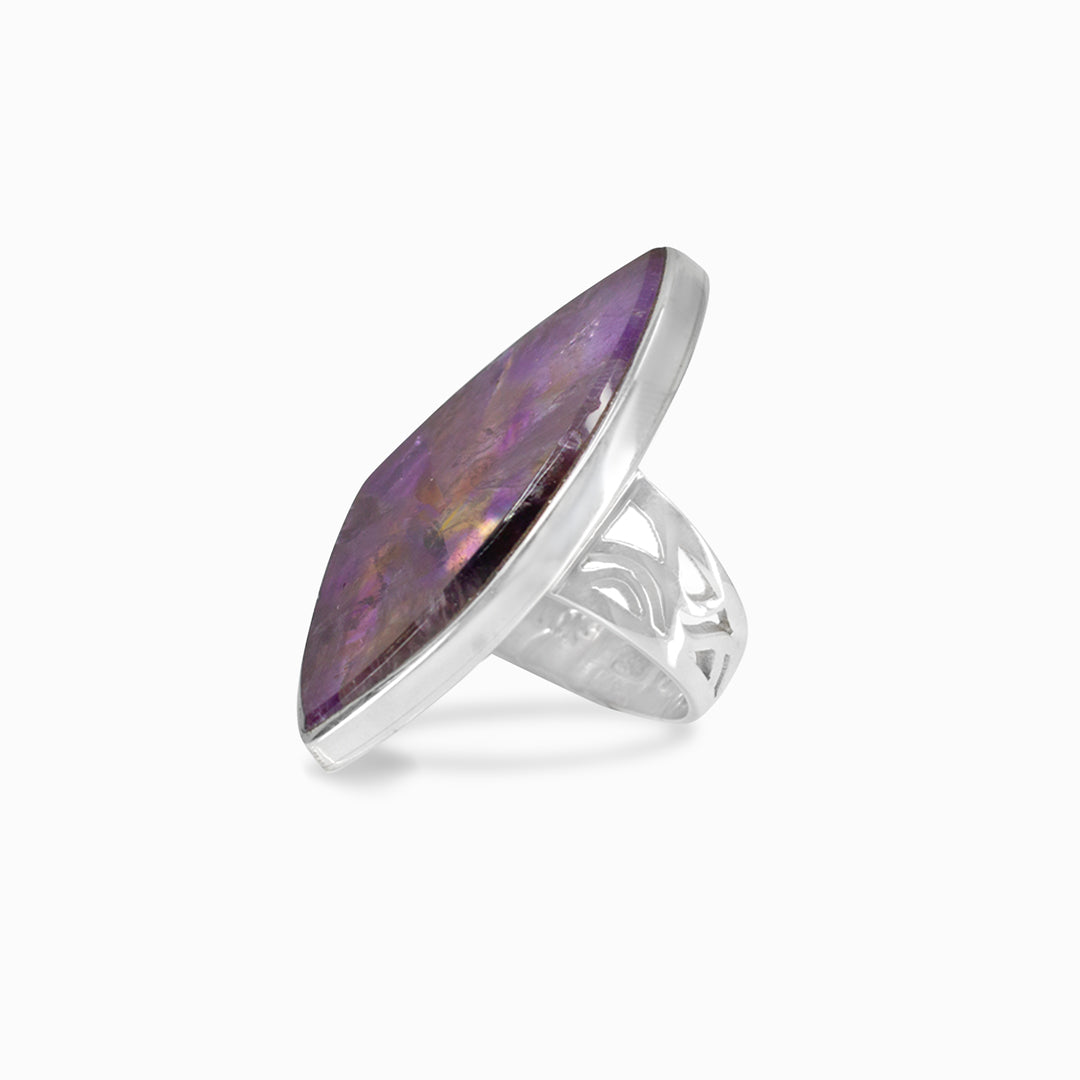 Silver ring with a purple gemstone on a white background