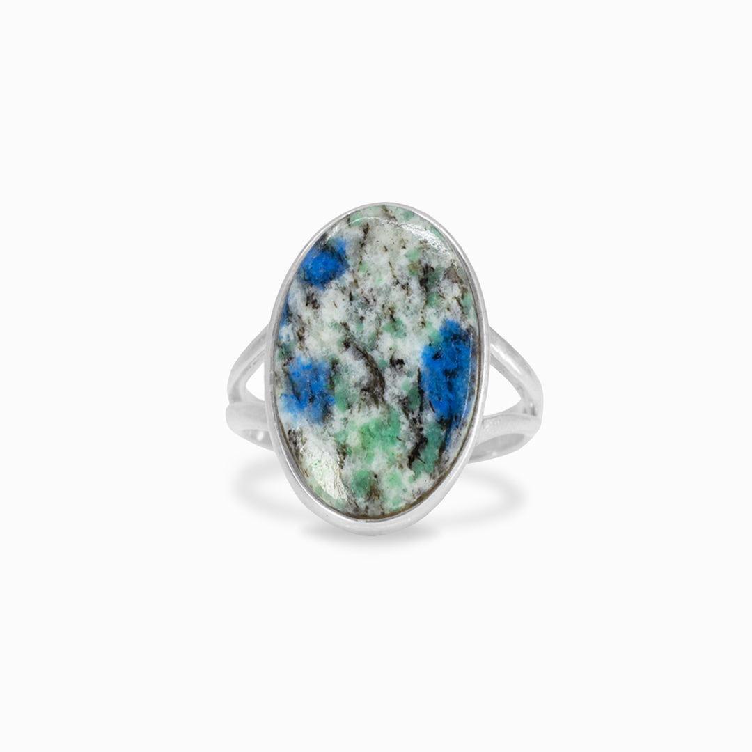 Silver ring with an oval stone featuring green and blue patterns on a white background