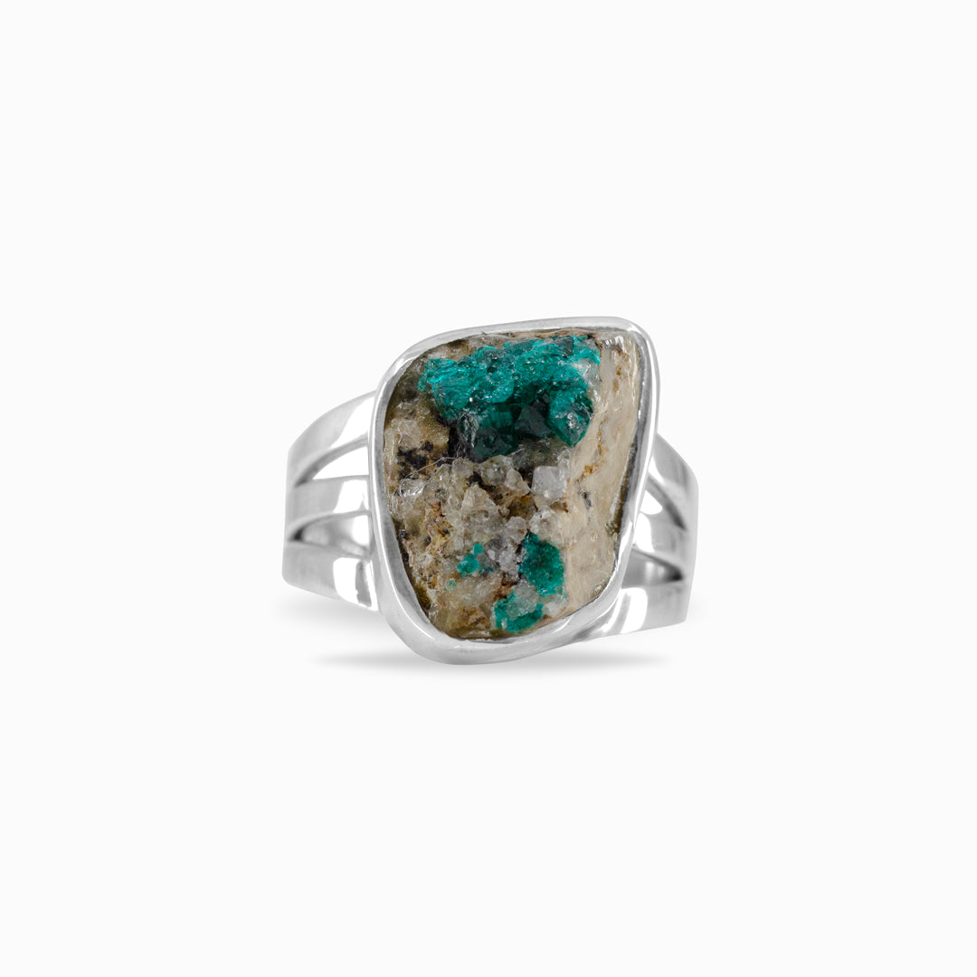 Silver ring with a rough freeform green gemstone on a white background