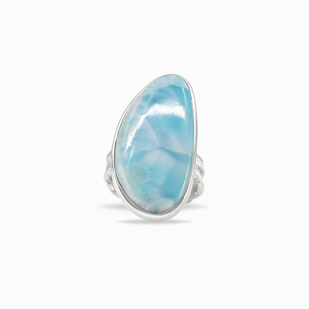 Silver ring with a light blue gemstone on a white background