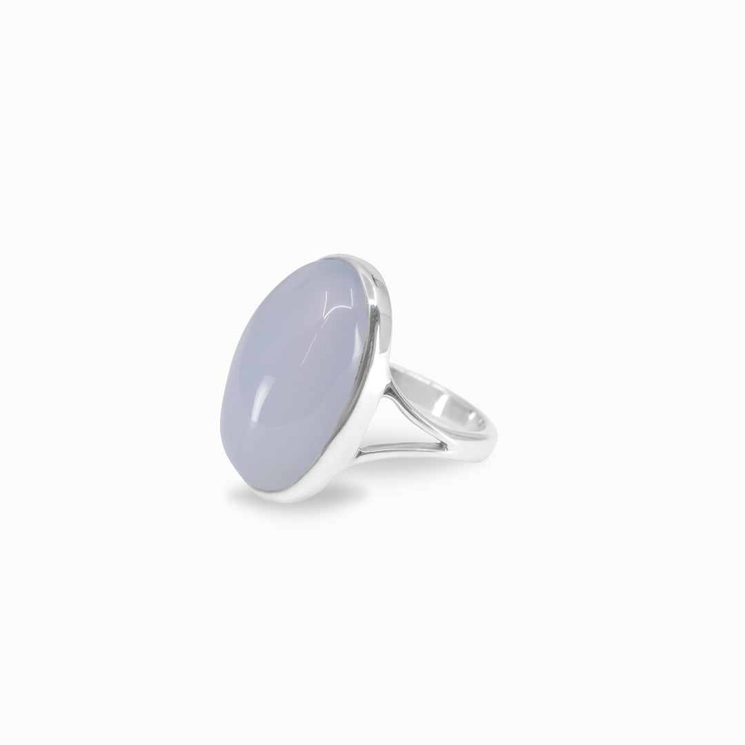 Silver ring with a light blue stone on a white background