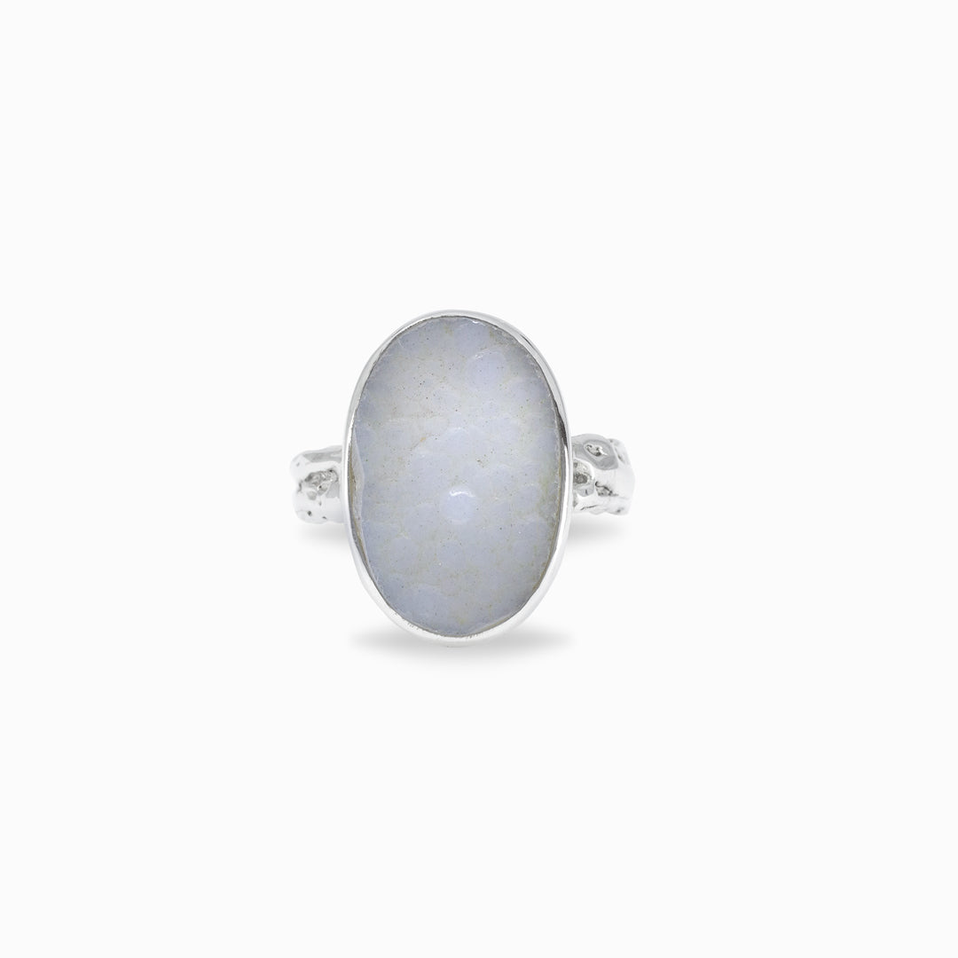 Silver ring with a light blue gemstone on a white background