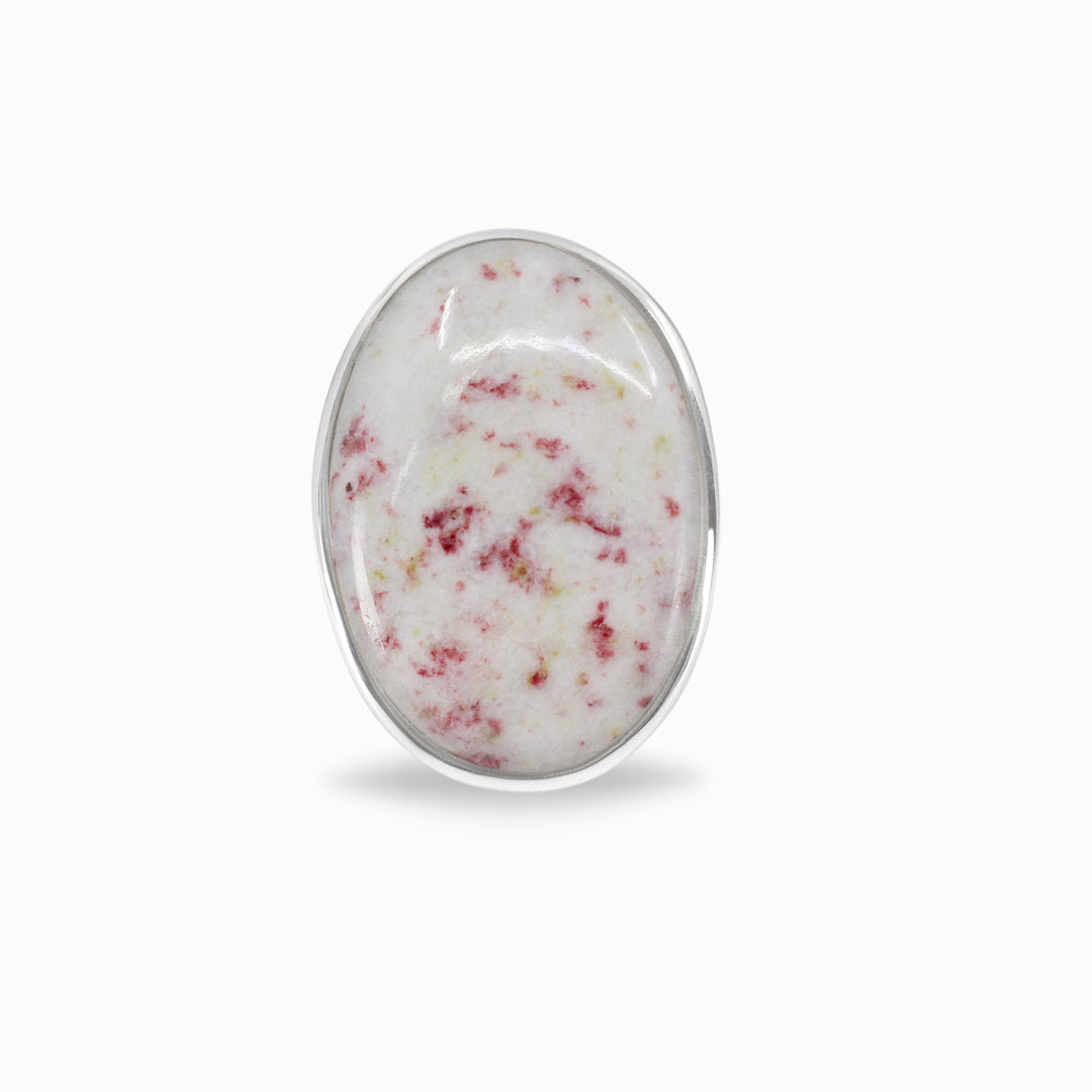 Oval-shaped white stone with red speckles on a white background