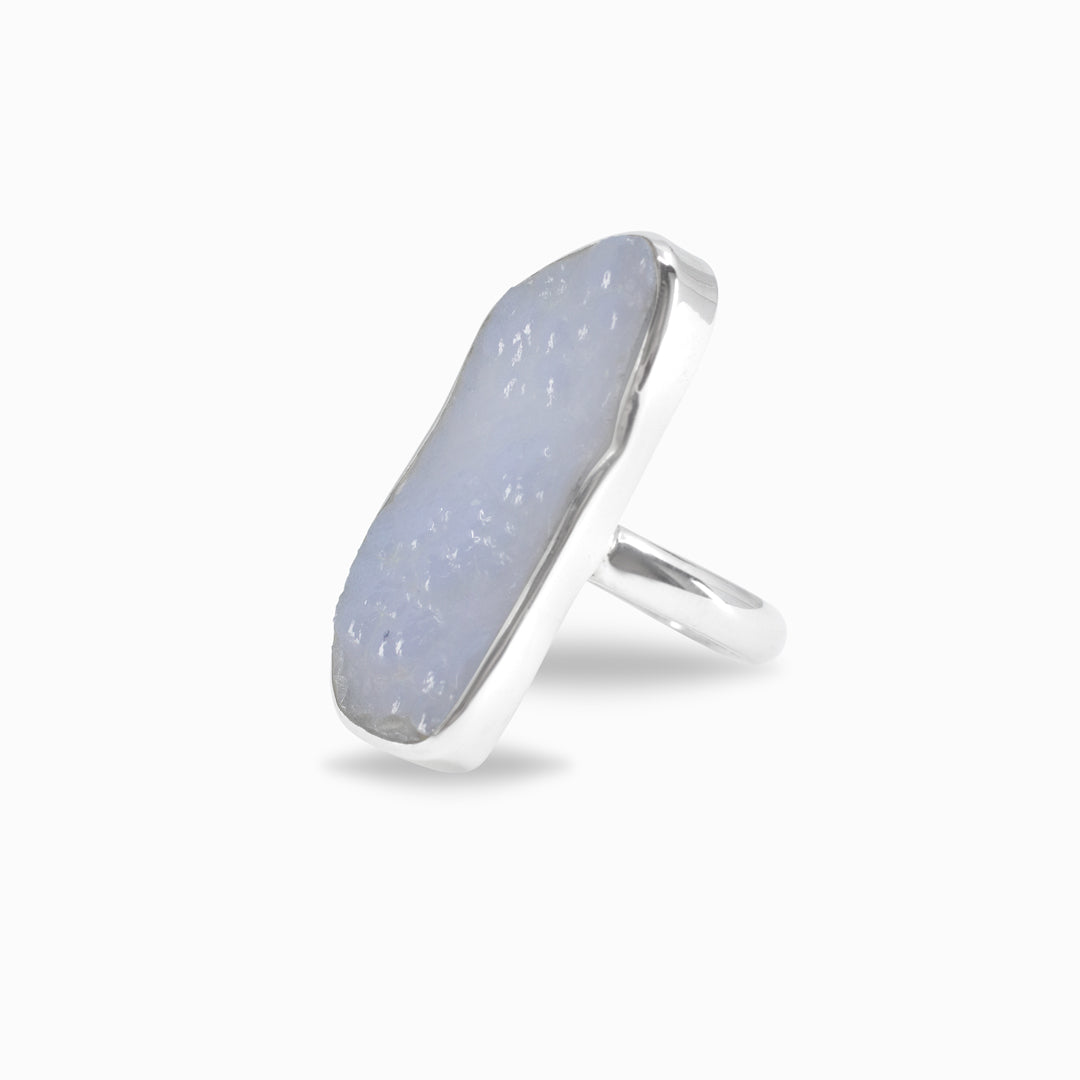 Silver ring with a light blue freeform stone on a white background