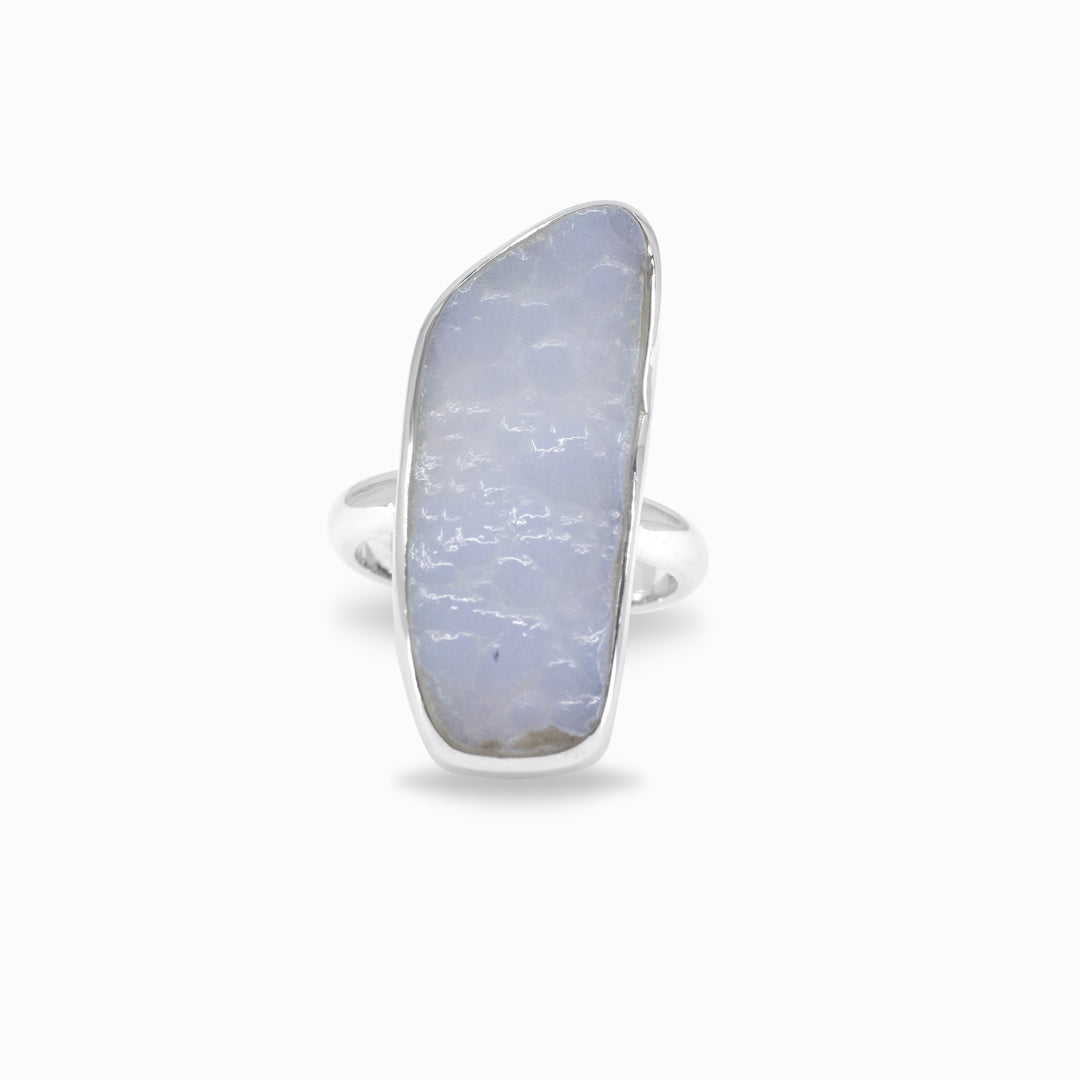 Silver ring with a light blue freeform stone on a white background