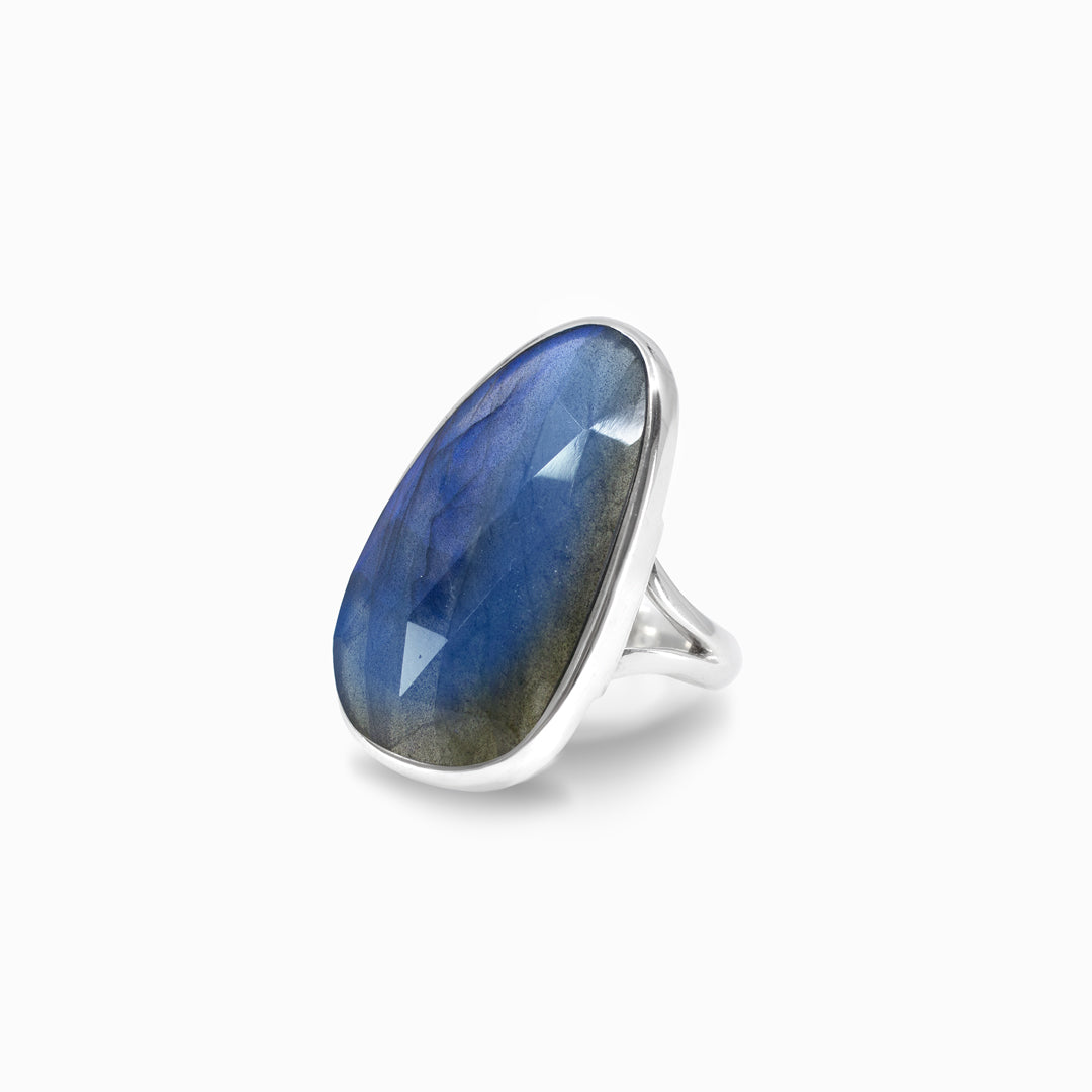 Silver ring with a blue gemstone on a white background