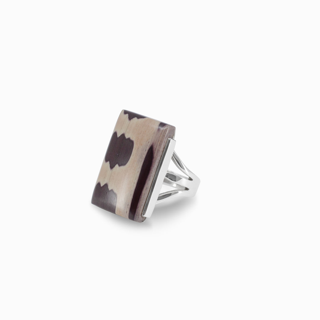 Silver ring with rectangular stone with brown pattern on a white background