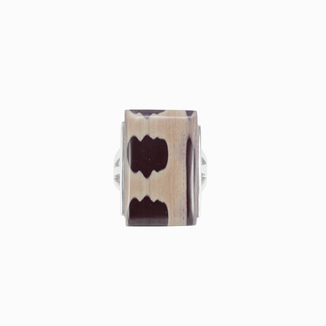 Silver ring with rectangular stone with brown pattern on a white background