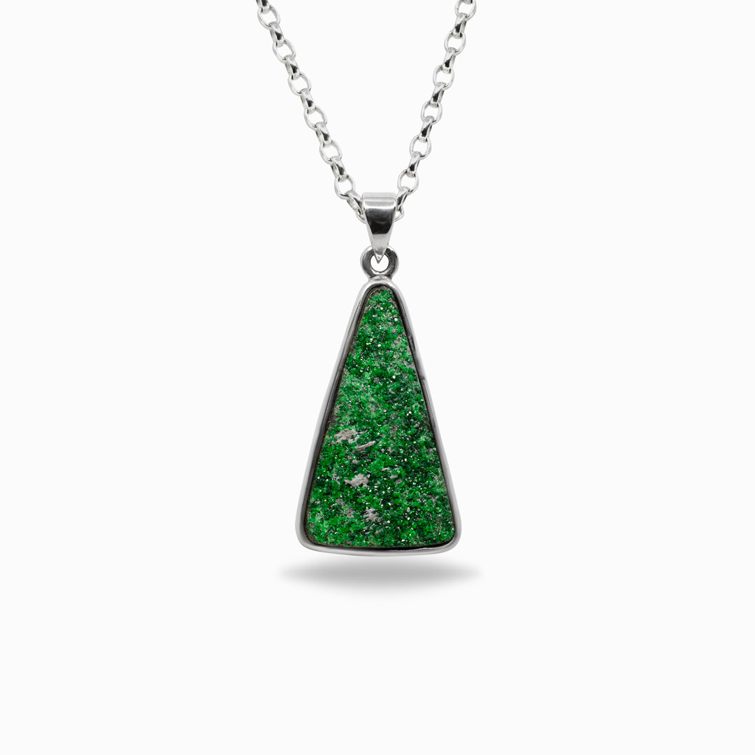 Green triangular pendant on a silver chain against a white background