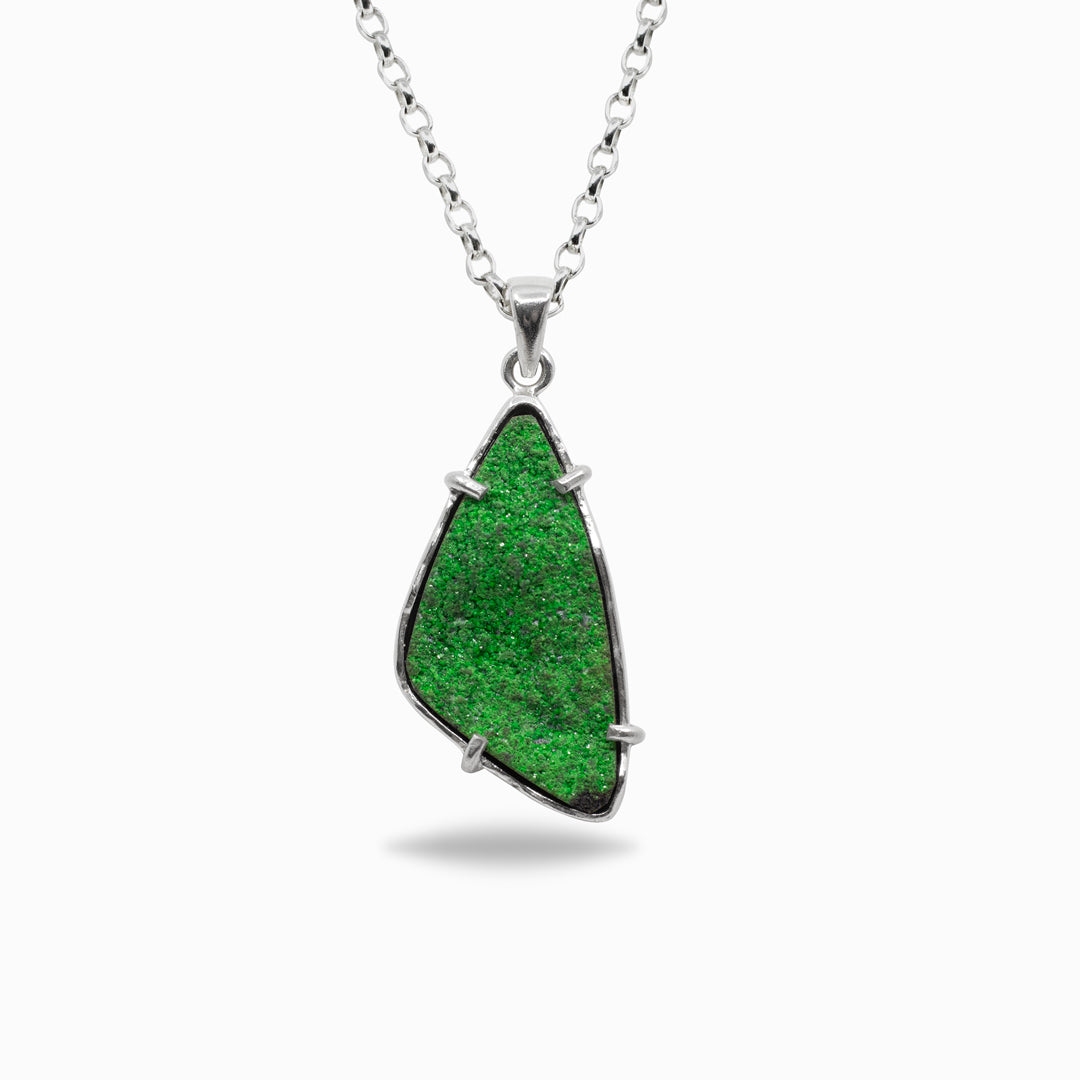Green freeform pendant on a white background