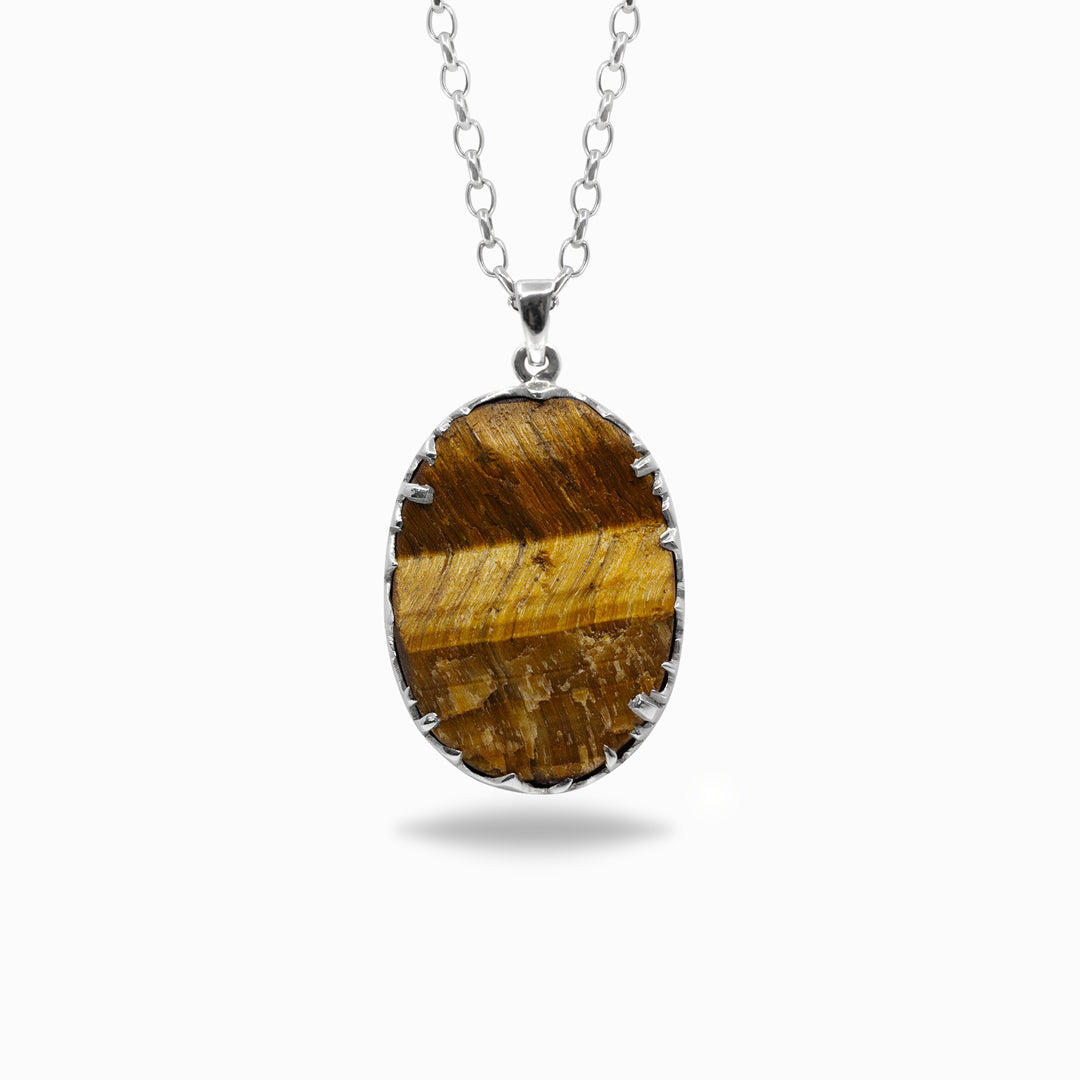 Tiger's Eye pendant on a silver chain against a white background