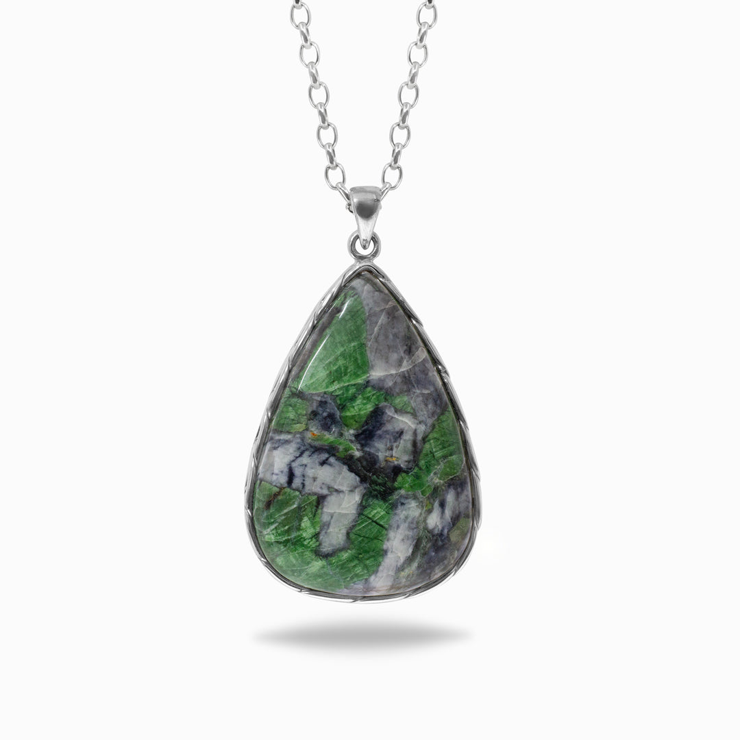 Teardrop-shaped green gemstone pendant on a chain against a white background