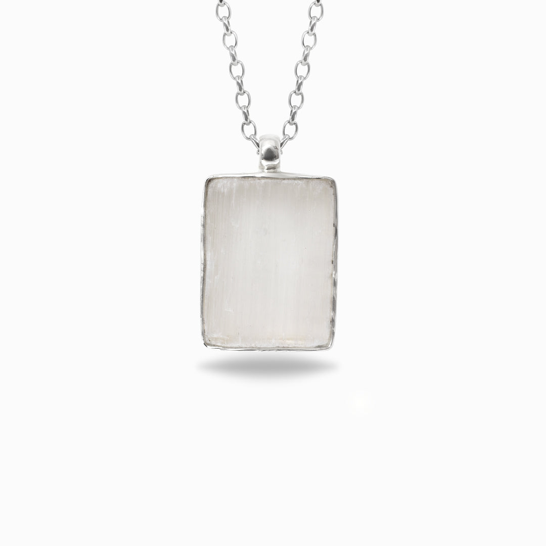 Silver rectangular pendant necklace on a white background