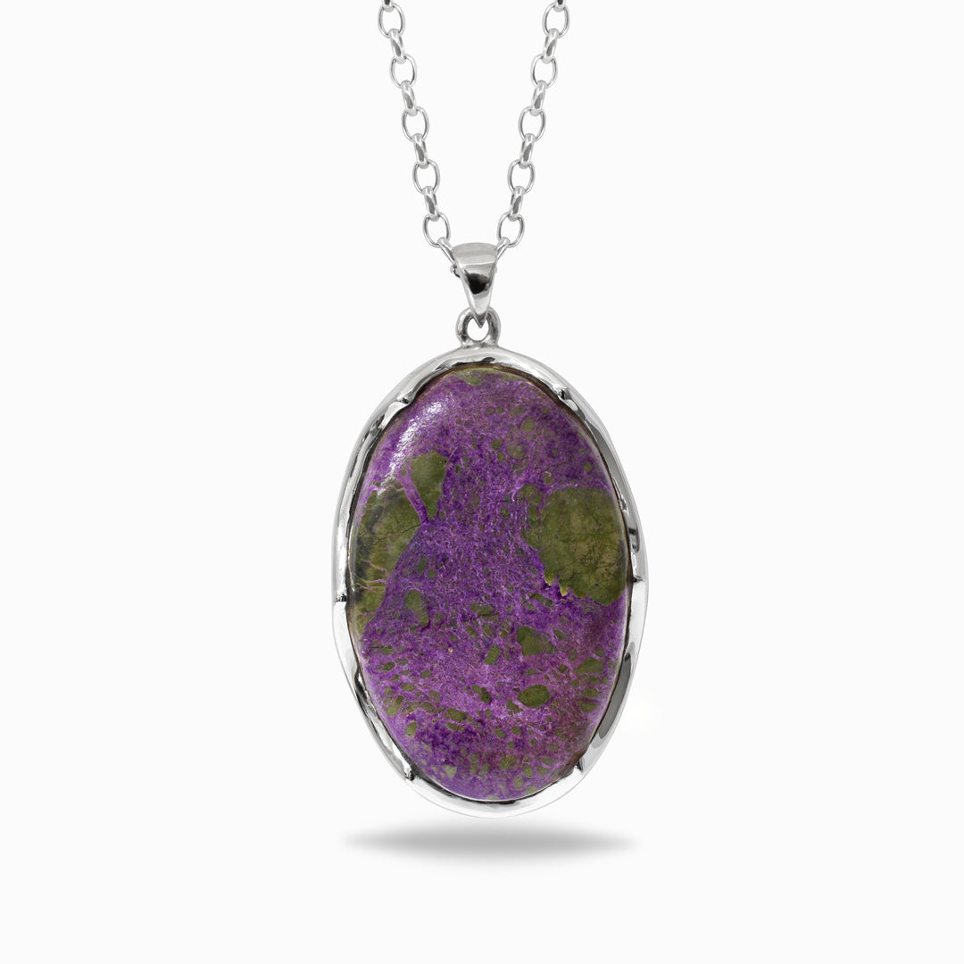 Silver necklace with purple and green stone against a white background