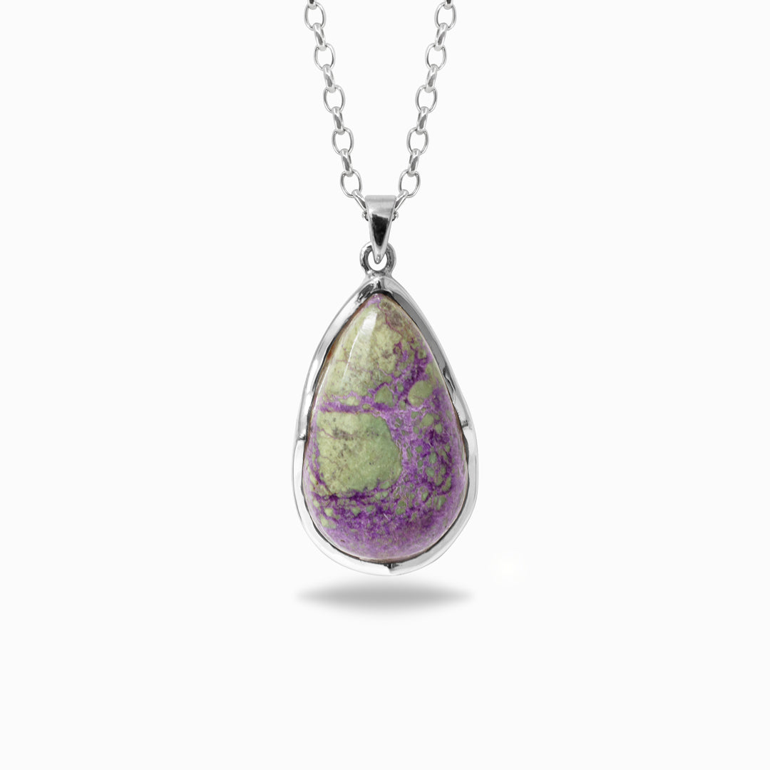 Silver necklace with a teardrop-shaped purple and green gemstone against a white background