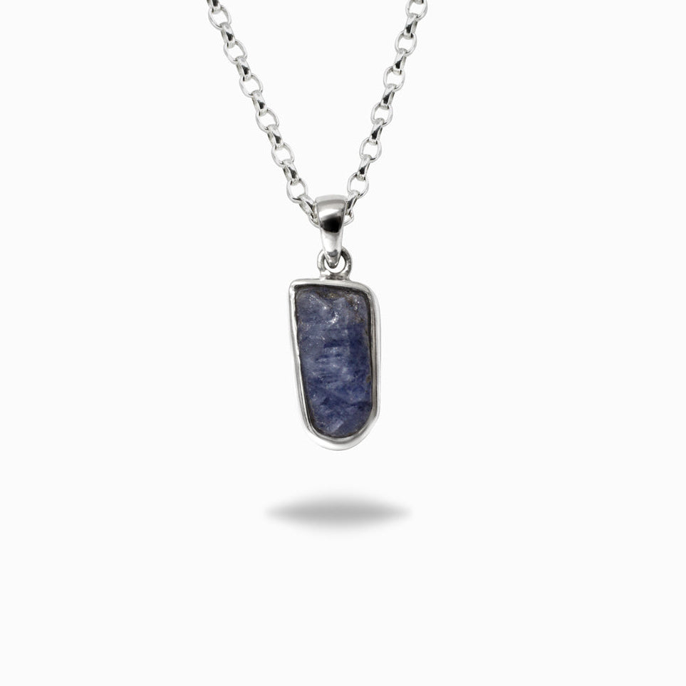 Silver necklace with a blue gemstone on a white background