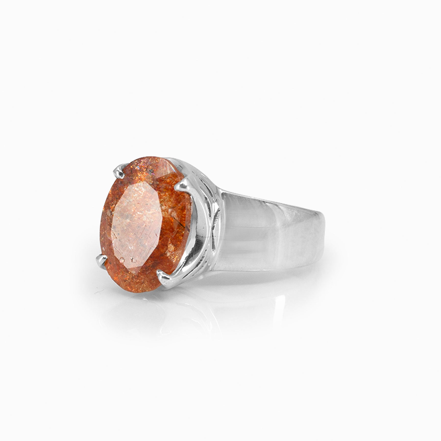 Silver ring with an orange gemstone on a white background