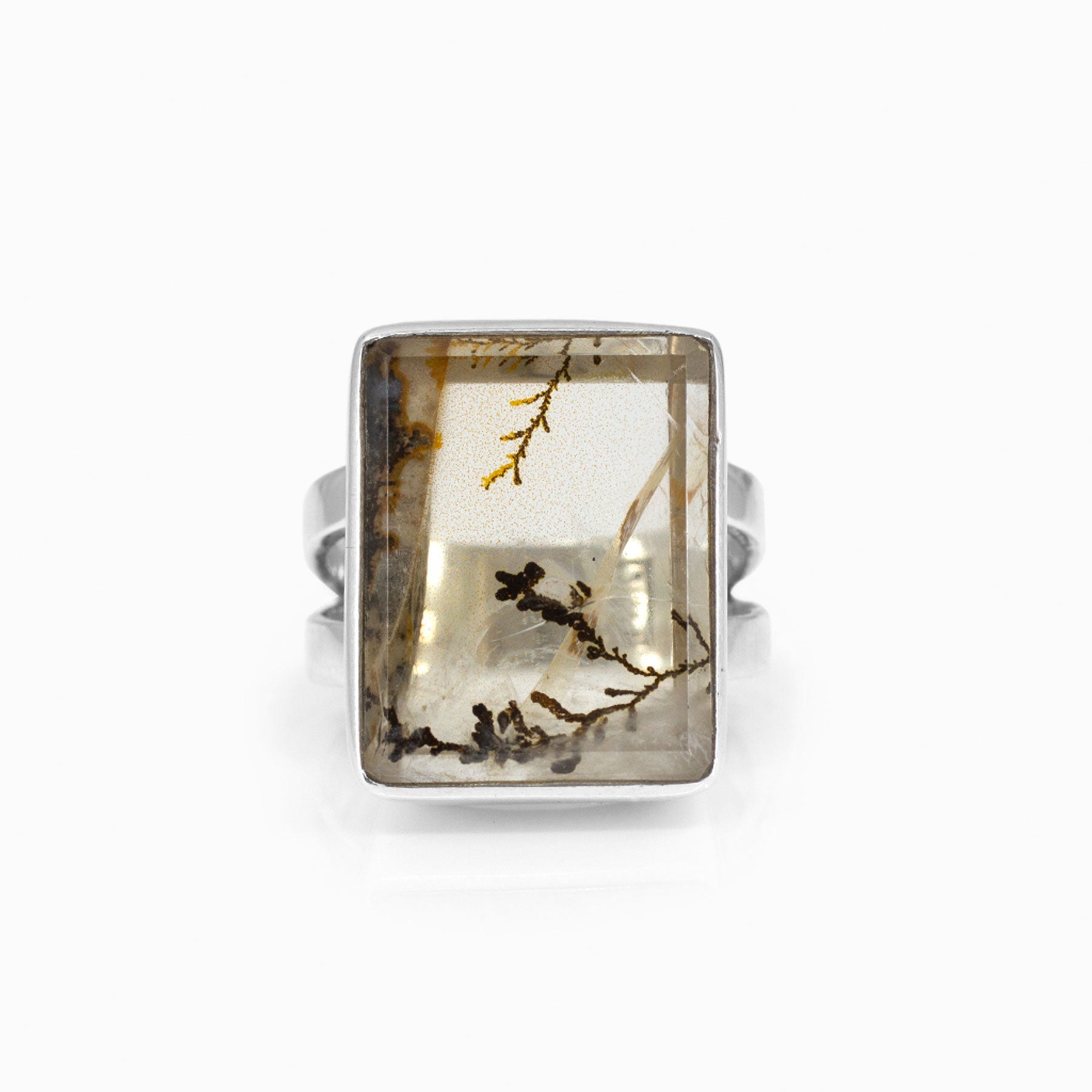 Silver ring with a rectangular clear stone featuring natural patterns on a white background
