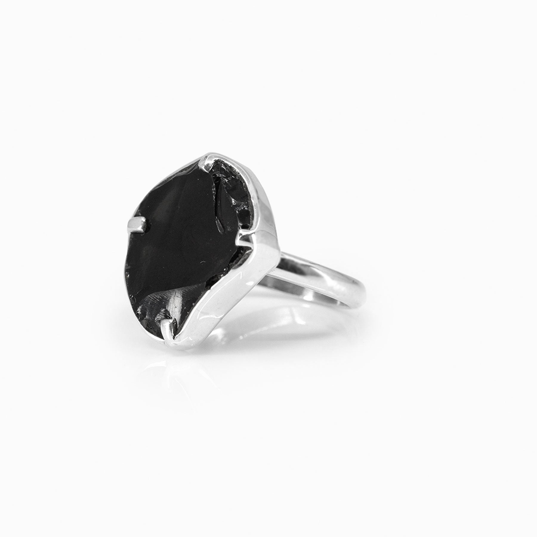 Silver ring with a black stone on a white background.