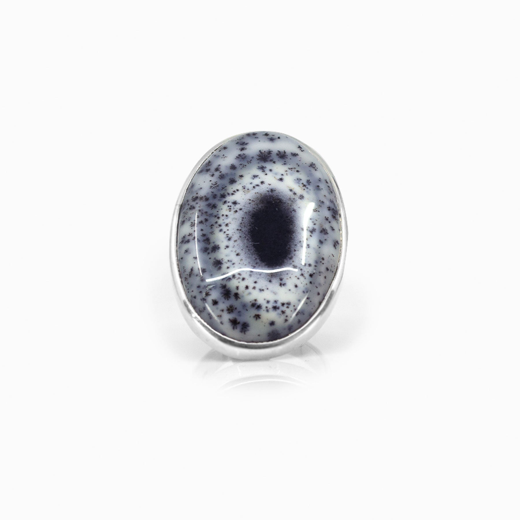 Silver ring with a speckled stone on a white background
