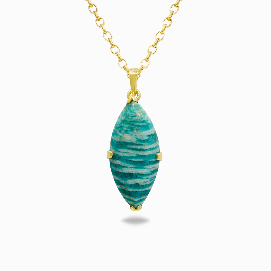 Golden necklace with a green pendant on a white background