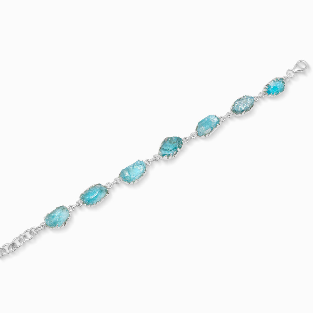 Silver bracelet with blue gemstones on a white background