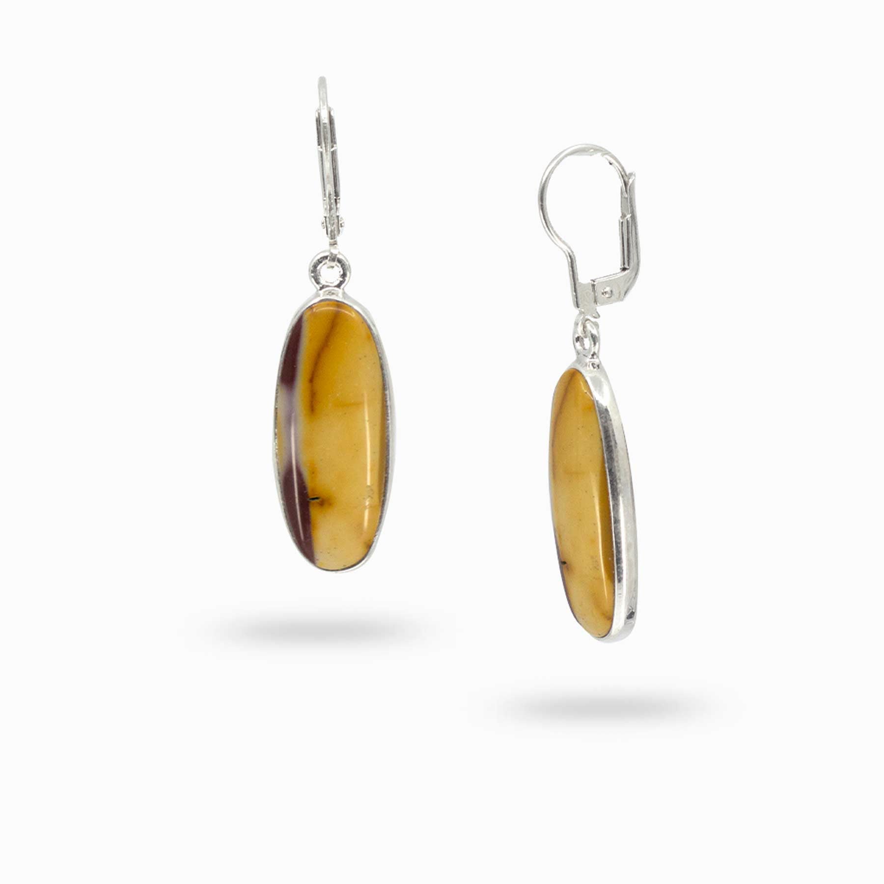 Pair of silver drop earrings with red and yellow gemstones on a white background