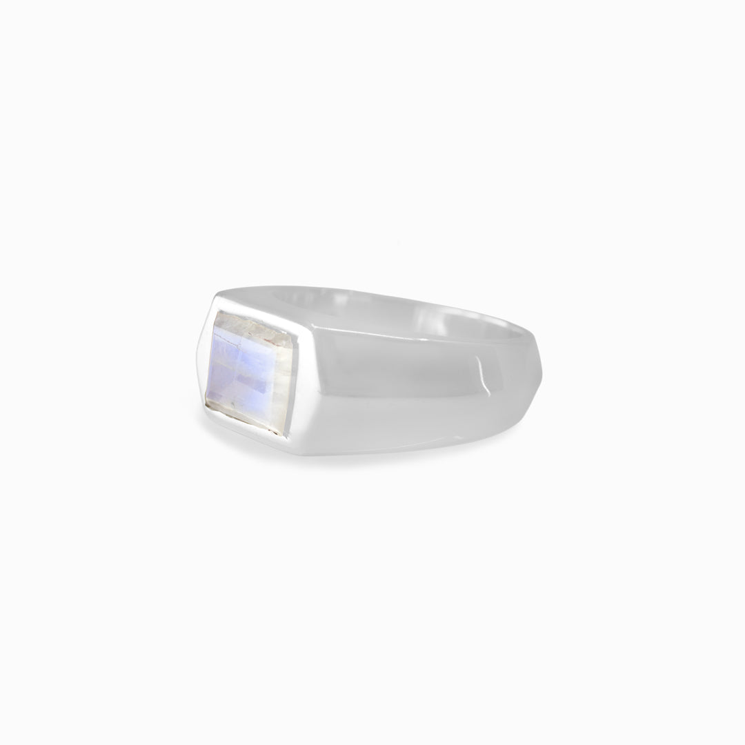 Silver ring with a rectangular gemstone on a white background