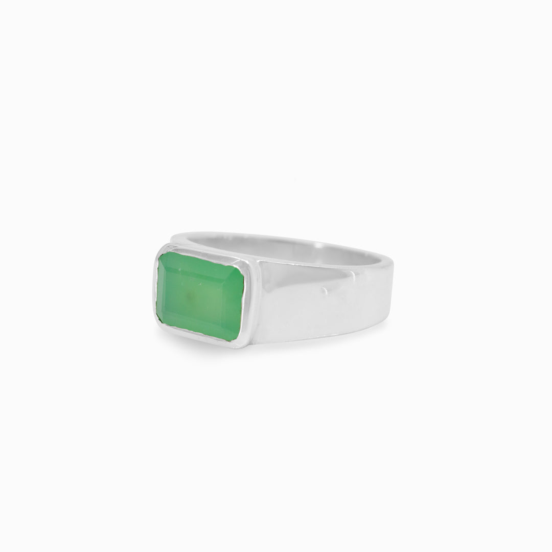 Silver ring with a green gemstone on a white background
