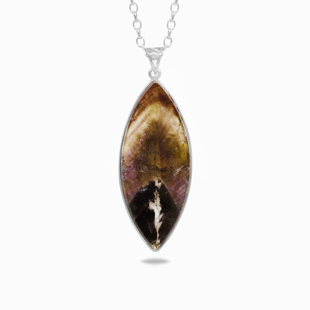 Marquise-shaped gemstone pendant on a silver chain against a white background