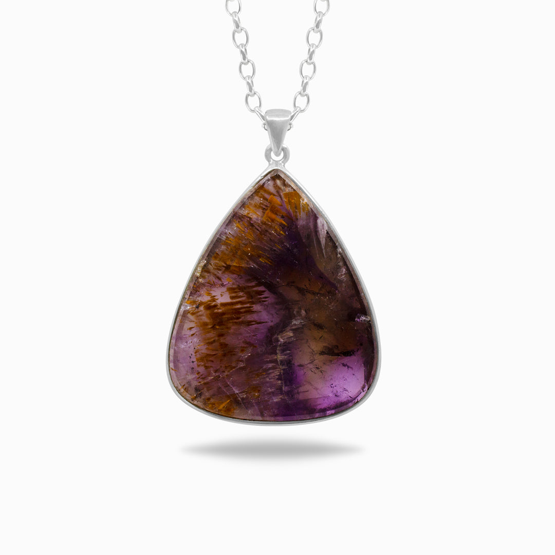 Silver necklace with a purple and yellow gemstone on a white background