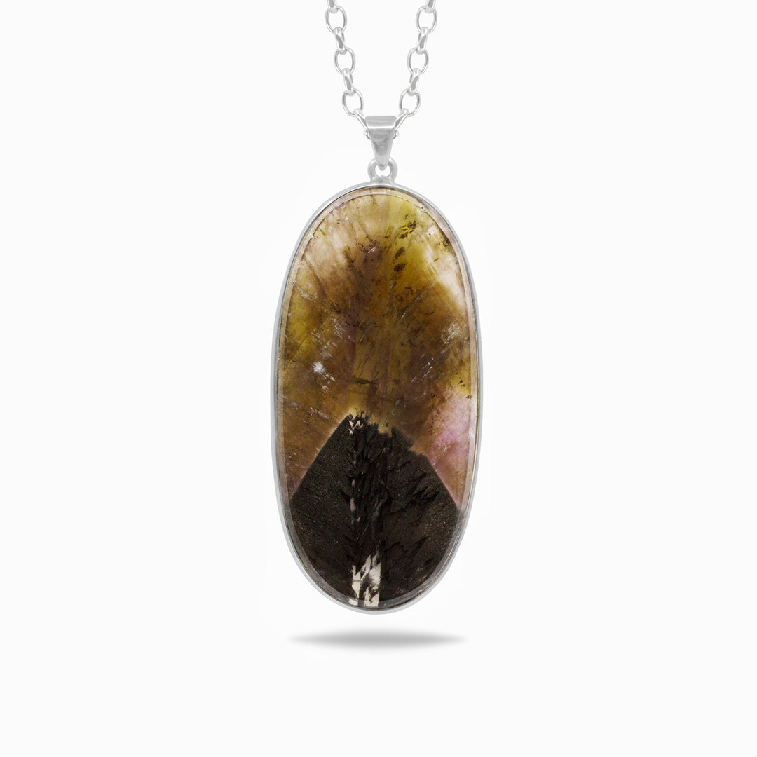 Silver necklace with a large oval pendant on a white background
