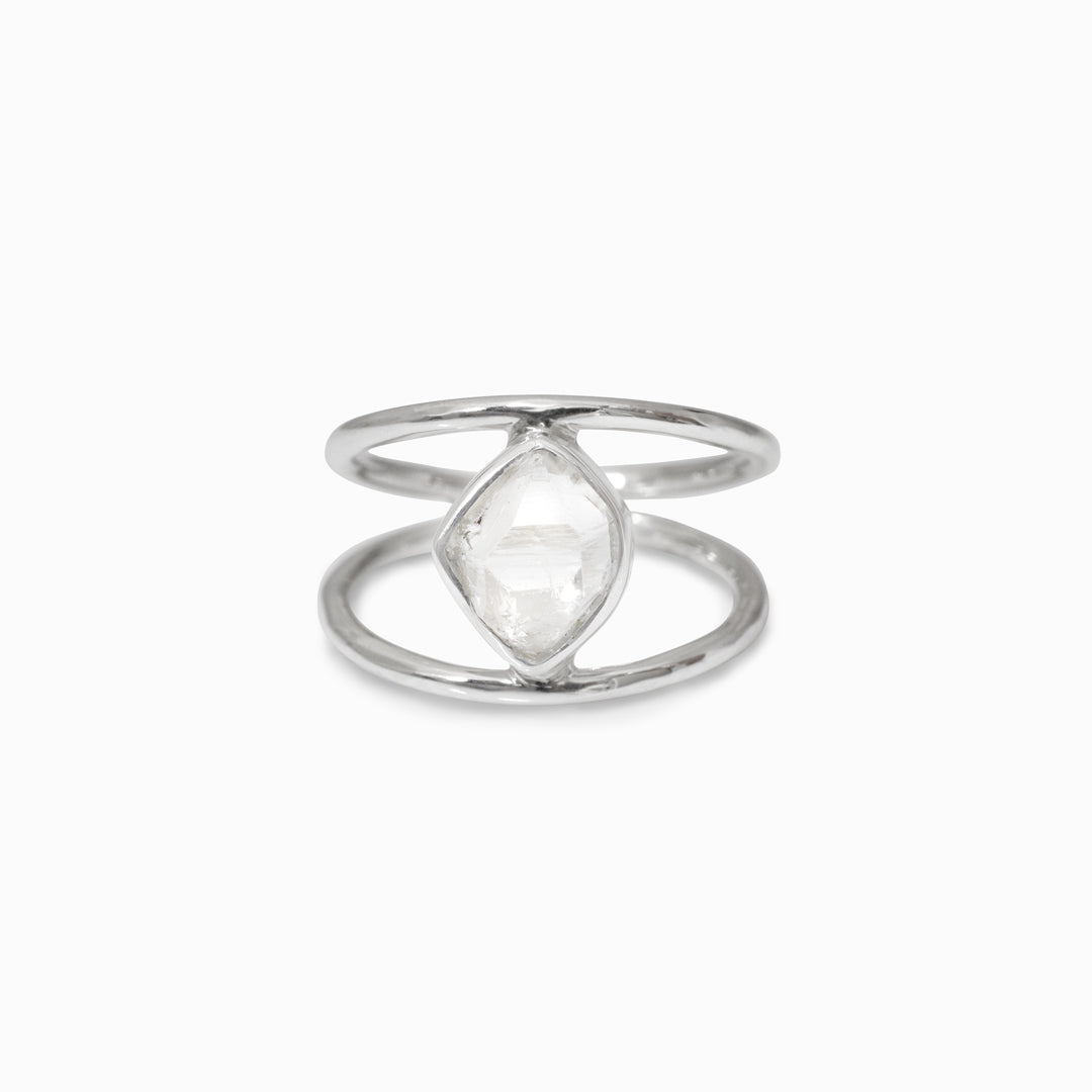 Silver ring with a freeform clear gemstone on a white background