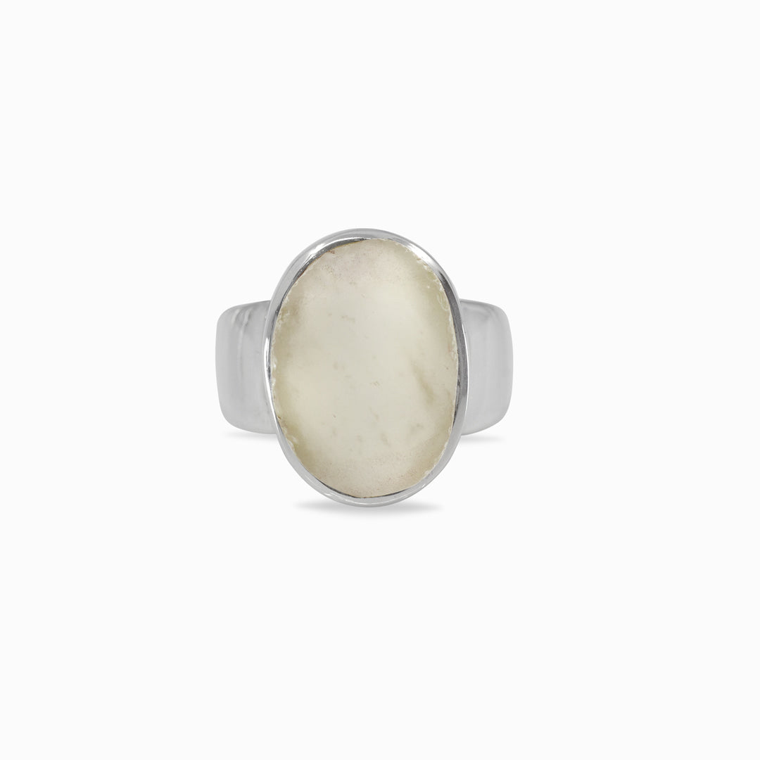 Silver ring with a light-colored stone on a white background
