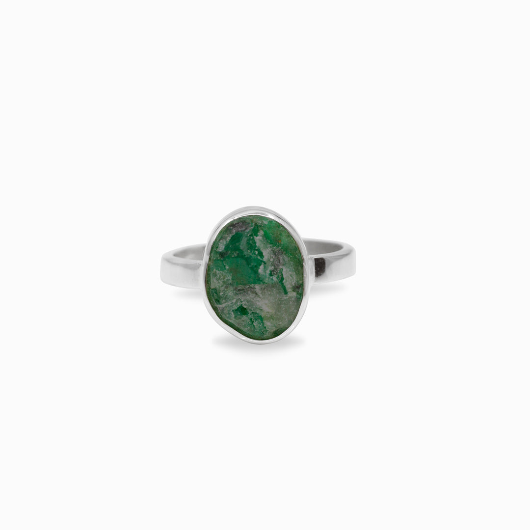 Silver ring with a green stone on a white background